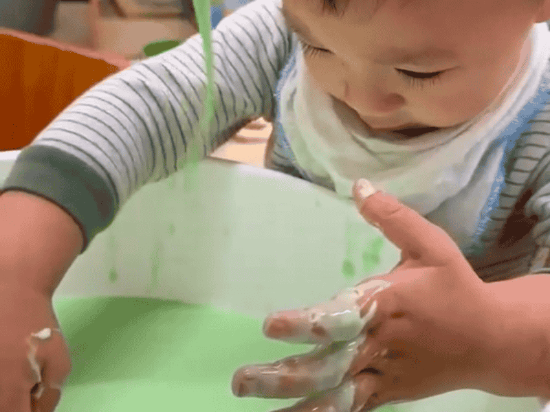KidsCo gloop A small child playing with sensory activity gloop inside a bowl